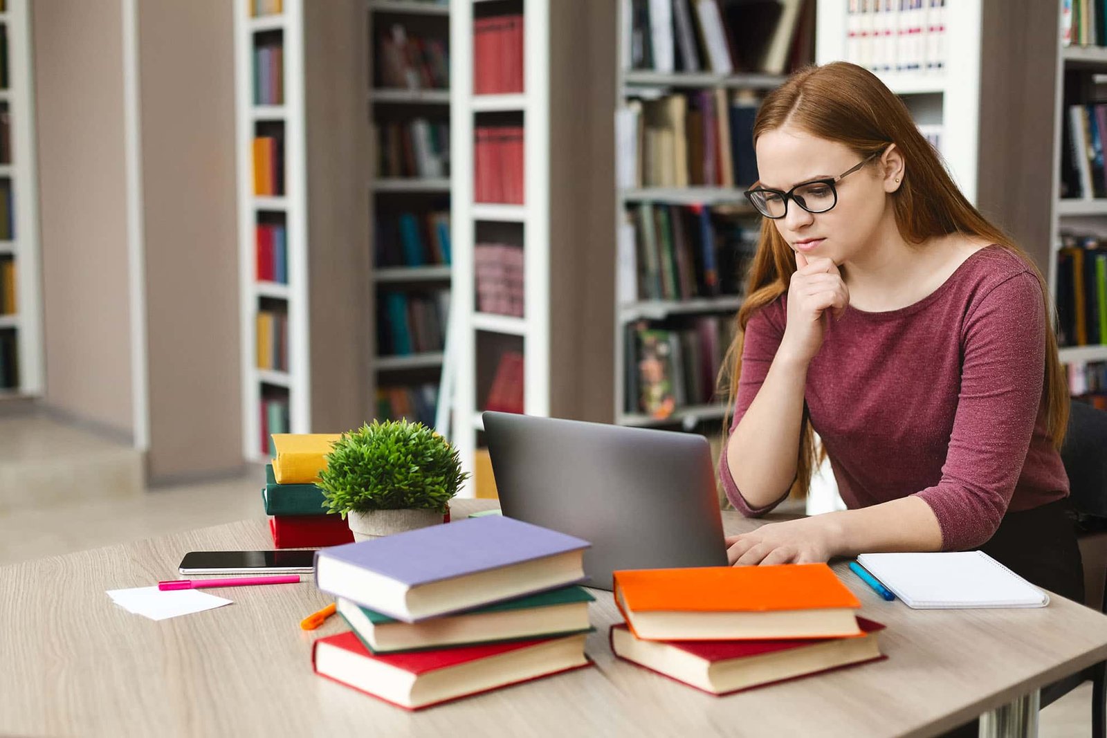 serious-student-girl-reading-science-article-onlin-24XF3Q7-min